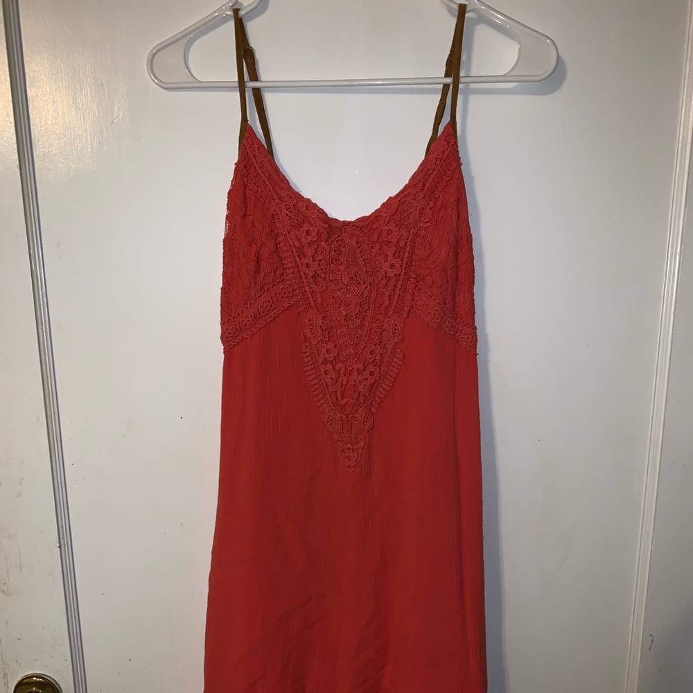 Burnt orange colored high low dress.